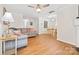 Bright and airy living room featuring modern wood floors, a ceiling fan, and seamlessly connected dining area at 3414 Chagall Ct, Charlotte, NC 28205