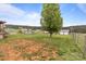 Large, expansive backyard featuring a tree, and a fenced-in area, with neighboring houses in the distance at 34958 Lowder Rd, New London, NC 28127