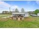 Exterior view of the back of the house with an expansive covered deck and well-maintained lawn at 34958 Lowder Rd, New London, NC 28127