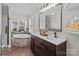 Luxurious bathroom features a deep soaking tub with brick surround, double vanity, and modern fixtures at 34958 Lowder Rd, New London, NC 28127