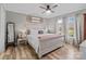 Bright main bedroom boasts a comfortable bed, ceiling fan, and wood-look flooring for a welcoming feel at 34958 Lowder Rd, New London, NC 28127