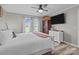 Bright main bedroom boasts a comfortable bed, ceiling fan, and wood-look flooring for a welcoming feel at 34958 Lowder Rd, New London, NC 28127