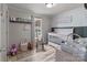 Well-lit Bedroom features a white crib, rocking chair, and neutral tones, creating a calming atmosphere at 34958 Lowder Rd, New London, NC 28127