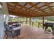Spacious covered deck featuring a lounge area, dining set, and outdoor grill, perfect for entertaining at 34958 Lowder Rd, New London, NC 28127