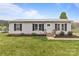 Inviting single-story home featuring a metal roof, neat landscaping, and a welcoming front entrance at 34958 Lowder Rd, New London, NC 28127
