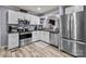 Updated kitchen boasts stainless steel appliances, sleek countertops, and ample cabinet space at 34958 Lowder Rd, New London, NC 28127