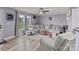 Bright living room features a large sectional sofa and large windows offering a view of the lawn at 34958 Lowder Rd, New London, NC 28127