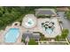 Aerial view of a resort-style pool area featuring multiple pools, water slides, lounge chairs, and lush landscaping at 4004 Henshaw Rd # 448, Waxhaw, NC 28173