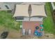 Aerial view of backyard with an outdoor kitchen, a hot tub, and lounge seating under a pergola at 4004 Henshaw Rd # 448, Waxhaw, NC 28173