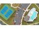 Aerial view showcasing tennis courts, a parking lot, and a community pool, surrounded by well-maintained landscaping at 4004 Henshaw Rd # 448, Waxhaw, NC 28173