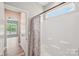 Bathroom with shower, tiled walls, and view into adjacent bedroom at 4004 Henshaw Rd # 448, Waxhaw, NC 28173