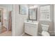 Well-lit bathroom featuring a single vanity, large mirror, and toilet at 4004 Henshaw Rd # 448, Waxhaw, NC 28173