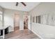 Neutral bedroom with desk, wood-look floors, and doorway views into hallway at 4004 Henshaw Rd # 448, Waxhaw, NC 28173