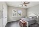 Cozy bedroom with wood floors, natural light, and a ceiling fan at 4004 Henshaw Rd # 448, Waxhaw, NC 28173