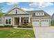 Charming home featuring a manicured lawn, inviting porch, and a convenient two-car garage enhancing curb appeal at 4004 Henshaw Rd # 448, Waxhaw, NC 28173