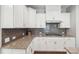 Well-lit kitchen featuring granite countertops, white cabinets, and a gray tile backsplash at 4004 Henshaw Rd # 448, Waxhaw, NC 28173