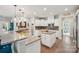 Bright, spacious kitchen featuring a central island, granite countertops, and modern white cabinetry at 4004 Henshaw Rd # 448, Waxhaw, NC 28173