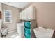 Bright laundry room with washer, sink, storage, and window for natural light at 4004 Henshaw Rd # 448, Waxhaw, NC 28173
