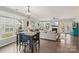 Open-concept layout seamlessly connects the dining and living areas with hardwood floors and natural light at 4004 Henshaw Rd # 448, Waxhaw, NC 28173