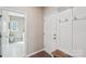 Mudroom featuring door to laundry room, hooks, bench, and exterior access at 4004 Henshaw Rd # 448, Waxhaw, NC 28173