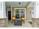 Cozy porch with rocking chairs and a charming table offers a relaxing outdoor space at 4004 Henshaw Rd # 448, Waxhaw, NC 28173