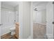 Bathroom with tub-shower, granite countertop, and wood-look flooring, adjoining bedroom at 423 Pleasant Ave, Kannapolis, NC 28081