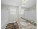 Bathroom with a granite countertop vanity and framed mirror. Features sleek, modern fixtures at 423 Pleasant Ave, Kannapolis, NC 28081