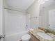 Bathroom featuring tub and shower combo, wood vanity and granite counter top with tile backsplash at 423 Pleasant Ave, Kannapolis, NC 28081