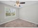 Bedroom showcasing a window, carpet, and ceiling fan providing natural light and comfort at 423 Pleasant Ave, Kannapolis, NC 28081
