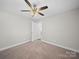 Bedroom with a ceiling fan, neutral walls and plush carpeting that creates a calming atmosphere at 423 Pleasant Ave, Kannapolis, NC 28081