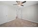 Bedroom featuring a carpeted floor, ceiling fan and a doorway leading to another room at 423 Pleasant Ave, Kannapolis, NC 28081