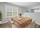Well-lit dining room with a wood table and seating for six at 423 Pleasant Ave, Kannapolis, NC 28081