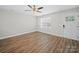Empty room with natural light, new flooring and a ceiling fan, ideal for customization at 423 Pleasant Ave, Kannapolis, NC 28081