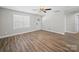 Bright, empty room with a ceiling fan, window, neutral walls, and wood-look flooring at 423 Pleasant Ave, Kannapolis, NC 28081