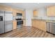 Well-lit kitchen featuring stainless steel appliances and wooden cabinetry for storage at 423 Pleasant Ave, Kannapolis, NC 28081