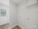 Clean laundry room features overhead shelving and convenient hookups, with easy access to the outside at 423 Pleasant Ave, Kannapolis, NC 28081