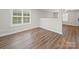 Bright living room boasts natural light from a window and features modern, wood-look flooring at 423 Pleasant Ave, Kannapolis, NC 28081