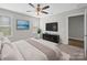 Relaxing main bedroom with neutral tones, featuring a ceiling fan and wall-mounted TVs at 423 Pleasant Ave, Kannapolis, NC 28081