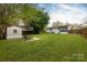 Landscaped backyard with a firepit area, perfect for cozy evenings and outdoor gatherings at 4244 Donnybrook Pl, Charlotte, NC 28205