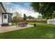Expansive backyard featuring patio dining and firepit areas, complemented by a storage shed and lush landscaping at 4244 Donnybrook Pl, Charlotte, NC 28205