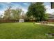 Spacious backyard with lush lawn, shed, firepit, and patio, ideal for recreation and outdoor enjoyment at 4244 Donnybrook Pl, Charlotte, NC 28205