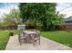 Backyard featuring a patio dining set and lush greenery, perfect for outdoor entertaining and relaxation at 4244 Donnybrook Pl, Charlotte, NC 28205