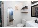 Bathroom featuring sleek fixtures, stylish shelves, and an arched mirror, creating a modern and functional space at 4244 Donnybrook Pl, Charlotte, NC 28205