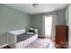 Comfortable bedroom with a daybed, hardwood floors, and lots of natural light at 4244 Donnybrook Pl, Charlotte, NC 28205