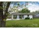 Beautiful home with lush greenery and a well-kept lawn, showcasing its inviting curb appeal at 4244 Donnybrook Pl, Charlotte, NC 28205