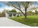 Charming home with a well-manicured lawn and inviting curb appeal, highlighted by mature trees at 4244 Donnybrook Pl, Charlotte, NC 28205