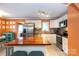 Open kitchen features stainless steel appliances, an island with breakfast bar and custom cabinetry at 4244 Donnybrook Pl, Charlotte, NC 28205