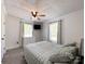 Light and airy bedroom with two windows, gray plank flooring and overhead fan at 4285 Palmer Lloyd Rd, Lancaster, SC 29720