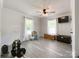 Bonus room with gray plank flooring, overhead lighting, weights and two windows at 4285 Palmer Lloyd Rd, Lancaster, SC 29720