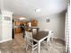 Open-concept dining area with tile floors, a wooden table, and a view into the kitchen at 4285 Palmer Lloyd Rd, Lancaster, SC 29720